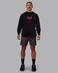 Man wearing Chrome Washed Heavyweight Oversized Long Sleeve Tee - Black-Ultra Orange | Model:Jaiden | Size:M | Thumbnail Index: 0