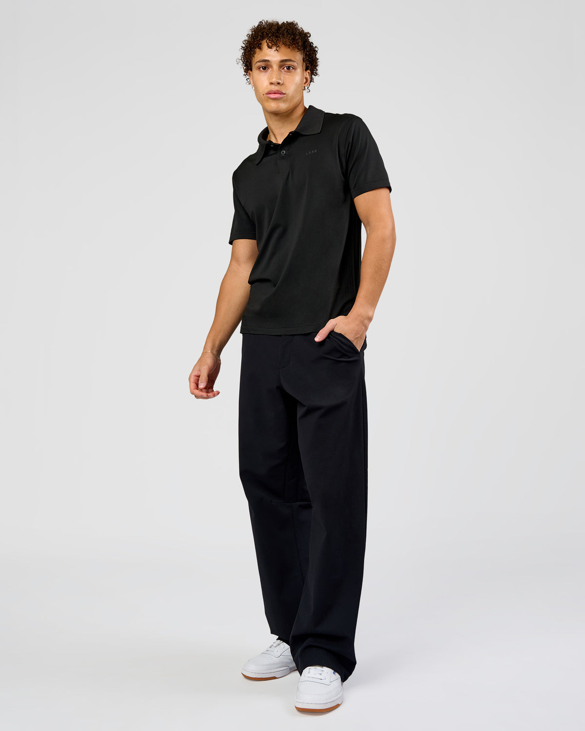 Man wearing Drive Seamless Polo - Black | Model:Leandro | Size:M
