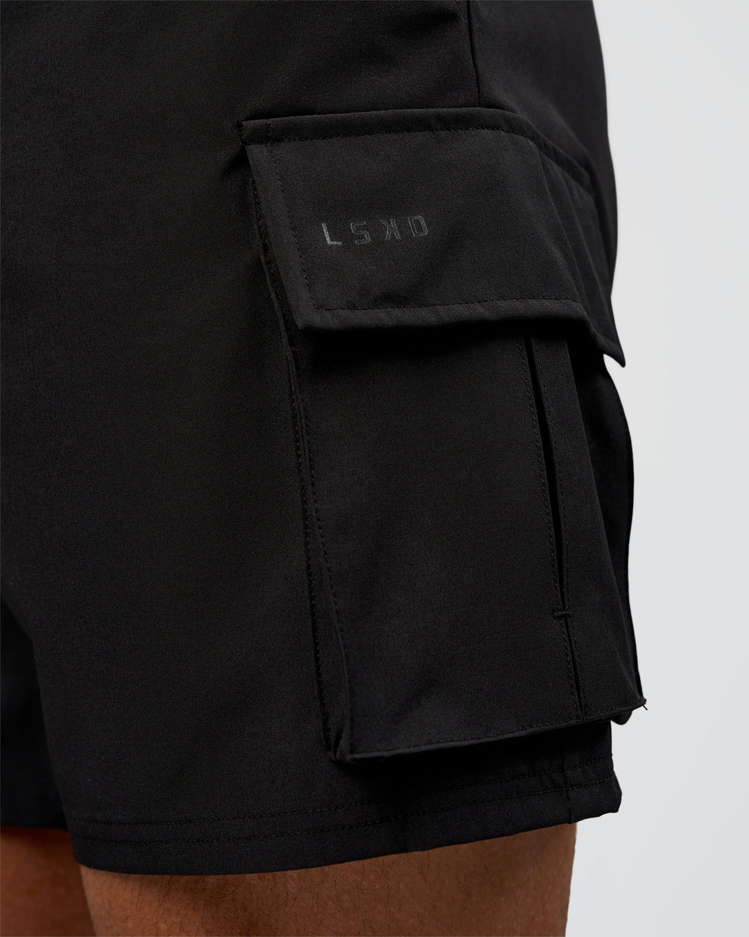 Man wearing Energy Stretch 6" Performance Cargo Short - Black | Model:Daarian | Size:M - view 6