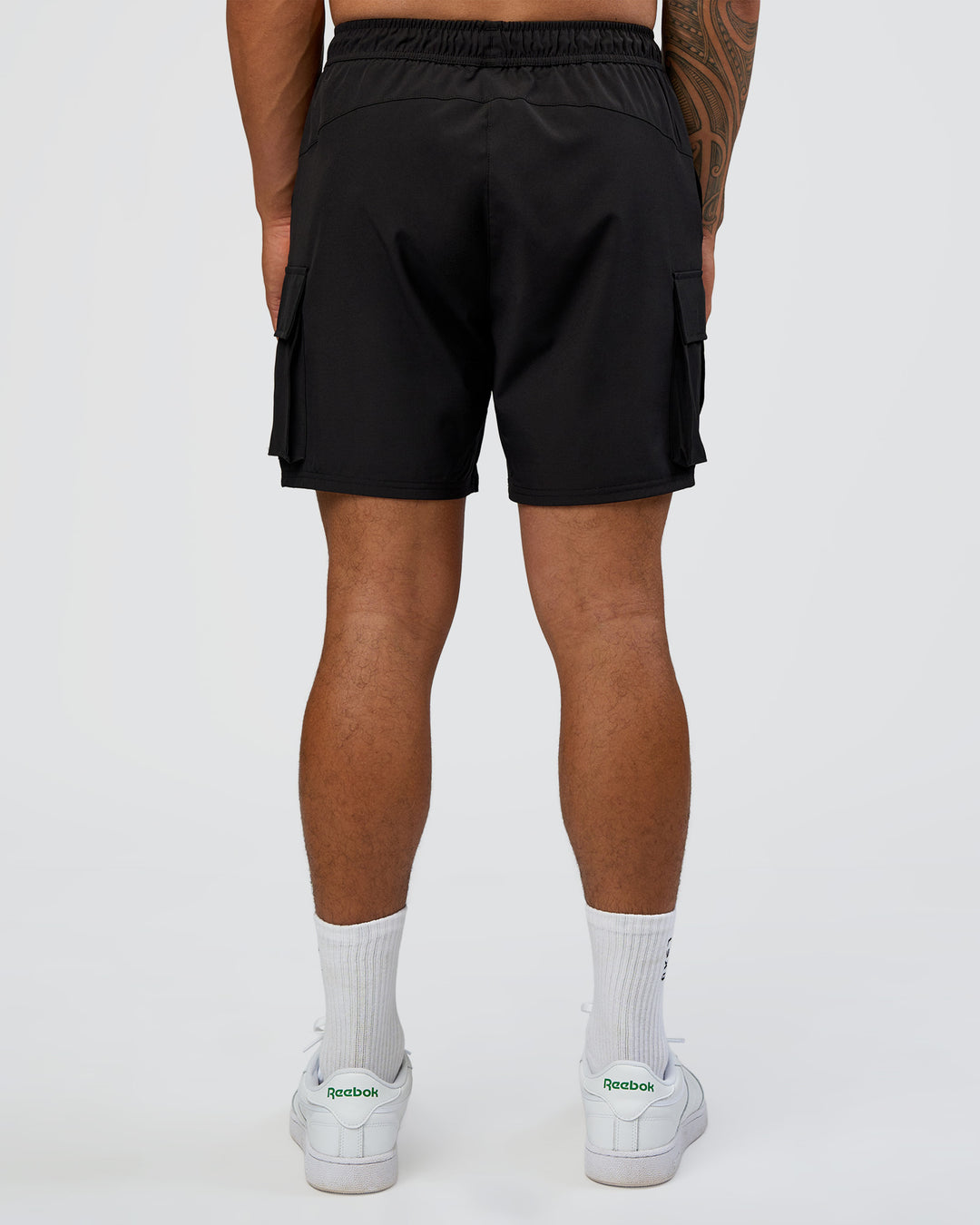 Man wearing Energy Stretch 6" Performance Cargo Short - Black | Model:Daarian | Size:M - view 4