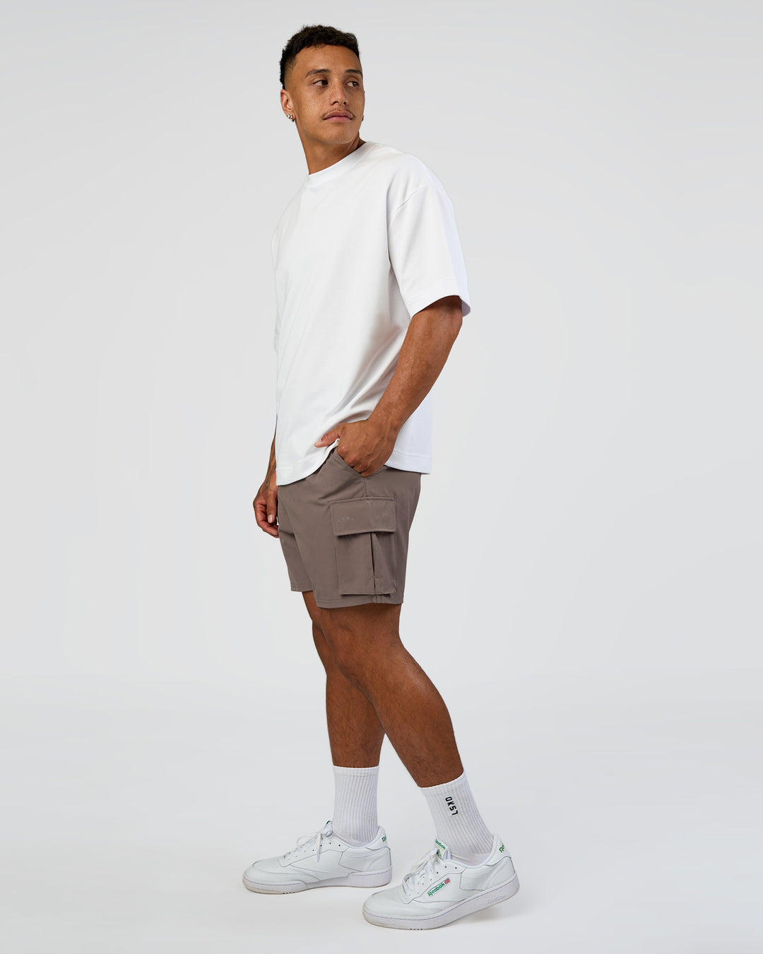 Man wearing Energy Stretch 6" Performance Cargo Short - Iron | Model:Daarian | Size:M - view 3