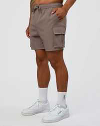 Man wearing Energy Stretch 6" Performance Cargo Short - Iron | Model:Daarian | Size:M | Thumbnail Index: 6