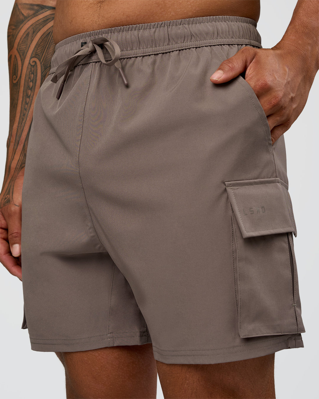 Man wearing Energy Stretch 6" Performance Cargo Short - Iron | Model:Daarian | Size:M - view 1