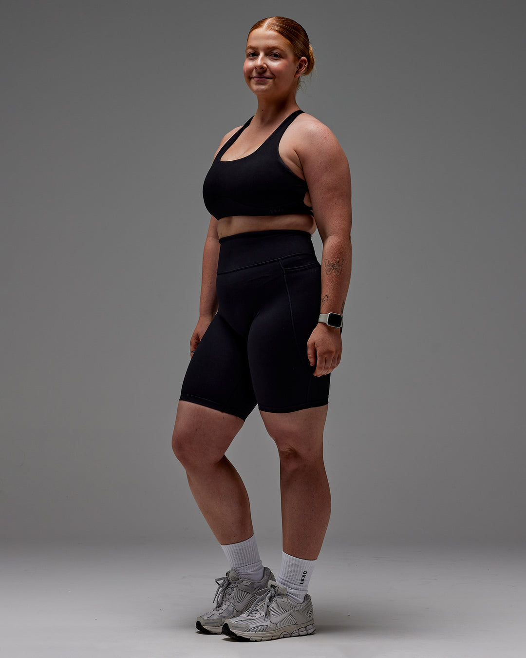 Woman wearing Fusion Ultra High-Rise 9" Short Pockets - Black | Model:Caity | Size:M - view 29
