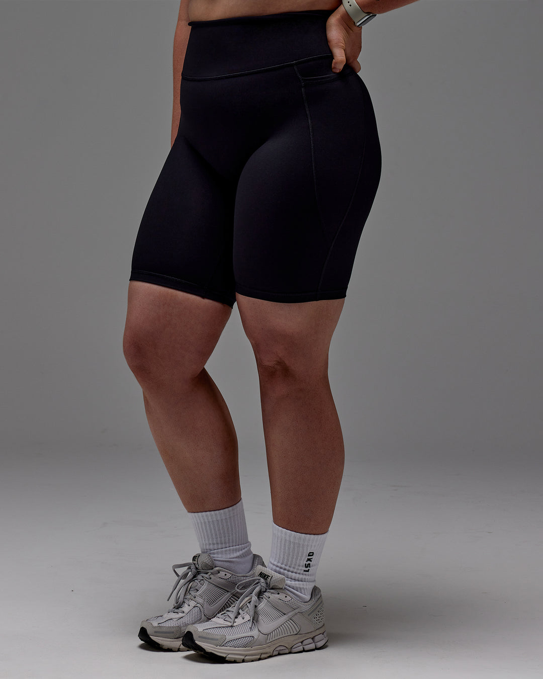Woman wearing Fusion Ultra High-Rise 9" Short Pockets - Black | Model:Caity | Size:M - view 30