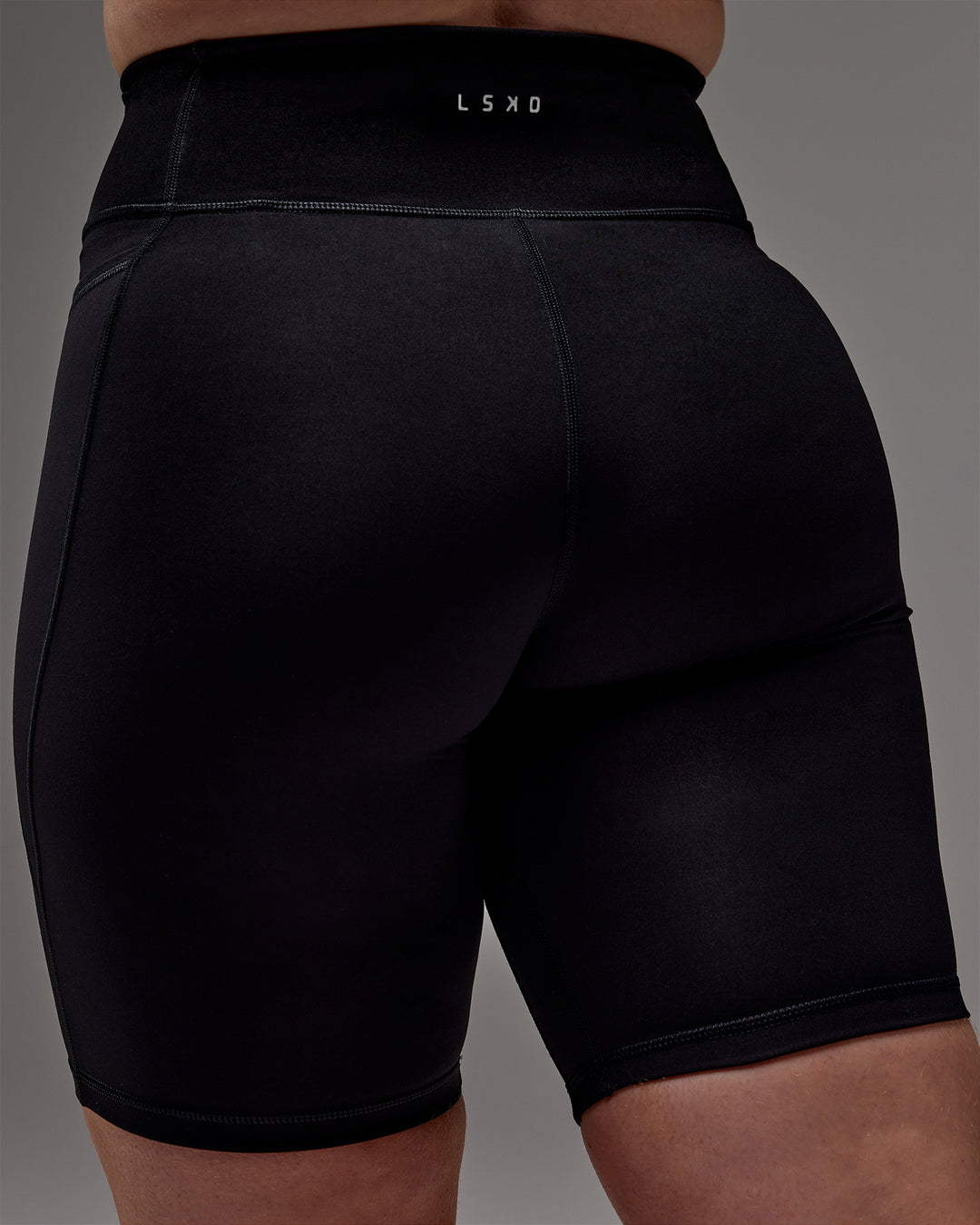 Woman wearing Fusion Ultra High-Rise 9" Short Pockets - Black | Model:Caity | Size:M - view 31