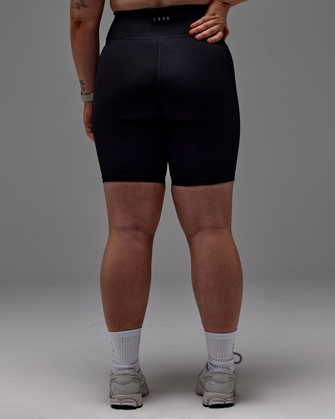 Woman wearing Fusion Ultra High-Rise 9" Short Pockets - Black | Model:Caity | Size:M - view 26