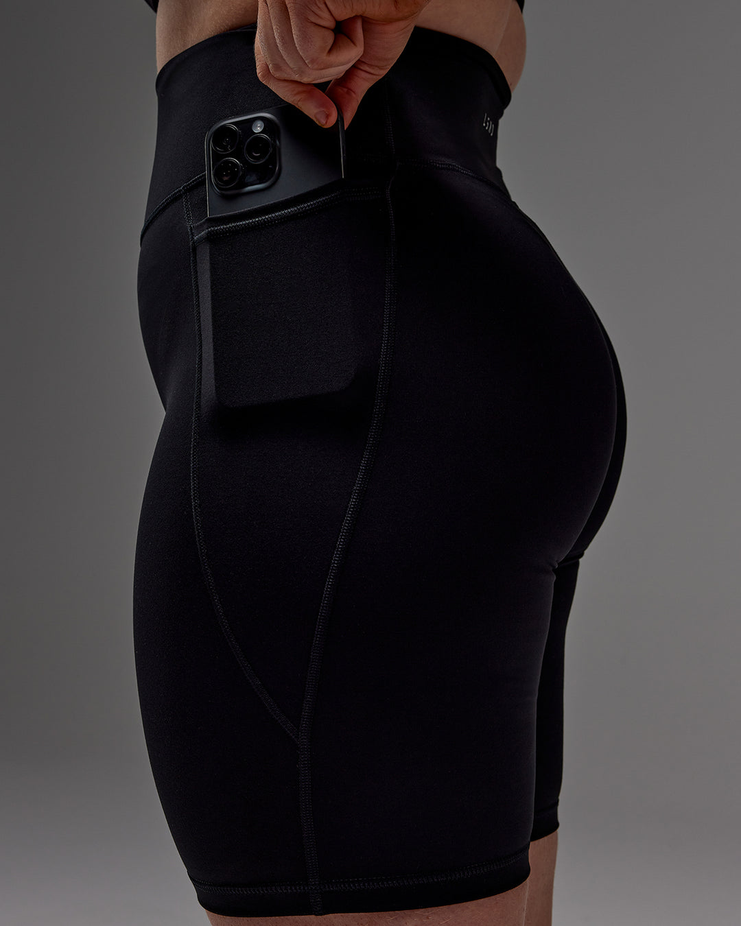 Woman wearing Fusion Ultra High-Rise 9" Short Pockets - Black | Model:Caity | Size:M - view 27