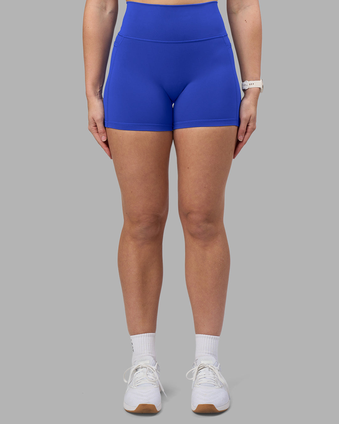 Woman wearing Fusion Ultra High-Rise 4" Short Pockets - Power Cobalt | Set:true | Angle:front | Model:Amy | Size:M - view 6
