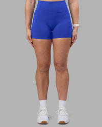 Woman wearing Fusion Ultra High-Rise 4" Short Pockets - Power Cobalt | Set:true | Angle:front | Model:Amy | Size:M | Thumbnail Index: 5