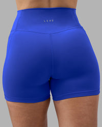Woman wearing Fusion Ultra High-Rise 4" Short Pockets - Power Cobalt | Model:Amy | Size:M | Thumbnail Index: 6