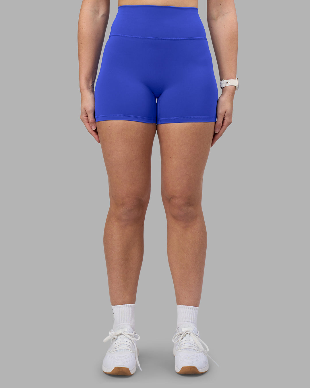 Woman wearing Fusion Ultra High-Rise 4" Short - Power Cobalt | Set:true | Angle:front | Model:Amy | Size:M - view 2