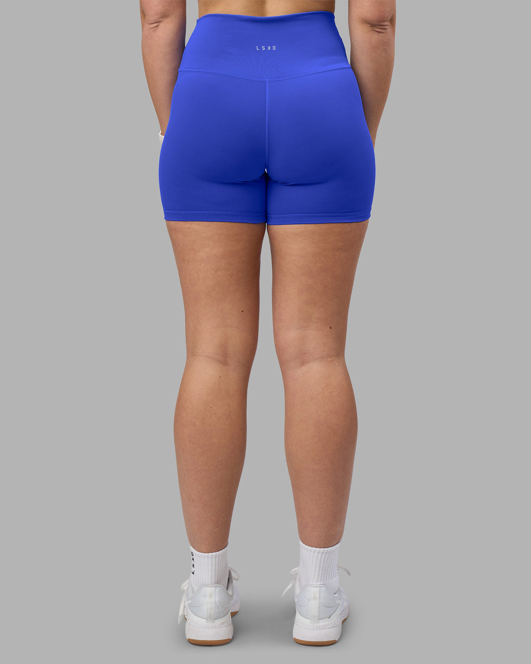 Woman wearing Fusion Ultra High-Rise 4" Short - Power Cobalt | Set:true | Angle:back | Model:Amy | Size:M - view 4