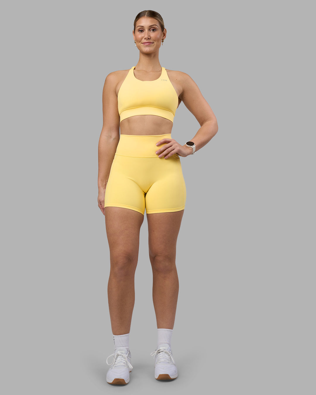 Woman wearing Fusion Ultra High-Rise 6" Short Pockets - Lemon | Model:Amy | Size:M - view 1