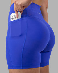 Woman wearing Fusion Ultra High-Rise 6" Short Pockets - Power Cobalt | Set:true | Angle:closeup | Model:Amy | Size:M | Thumbnail Index: 0