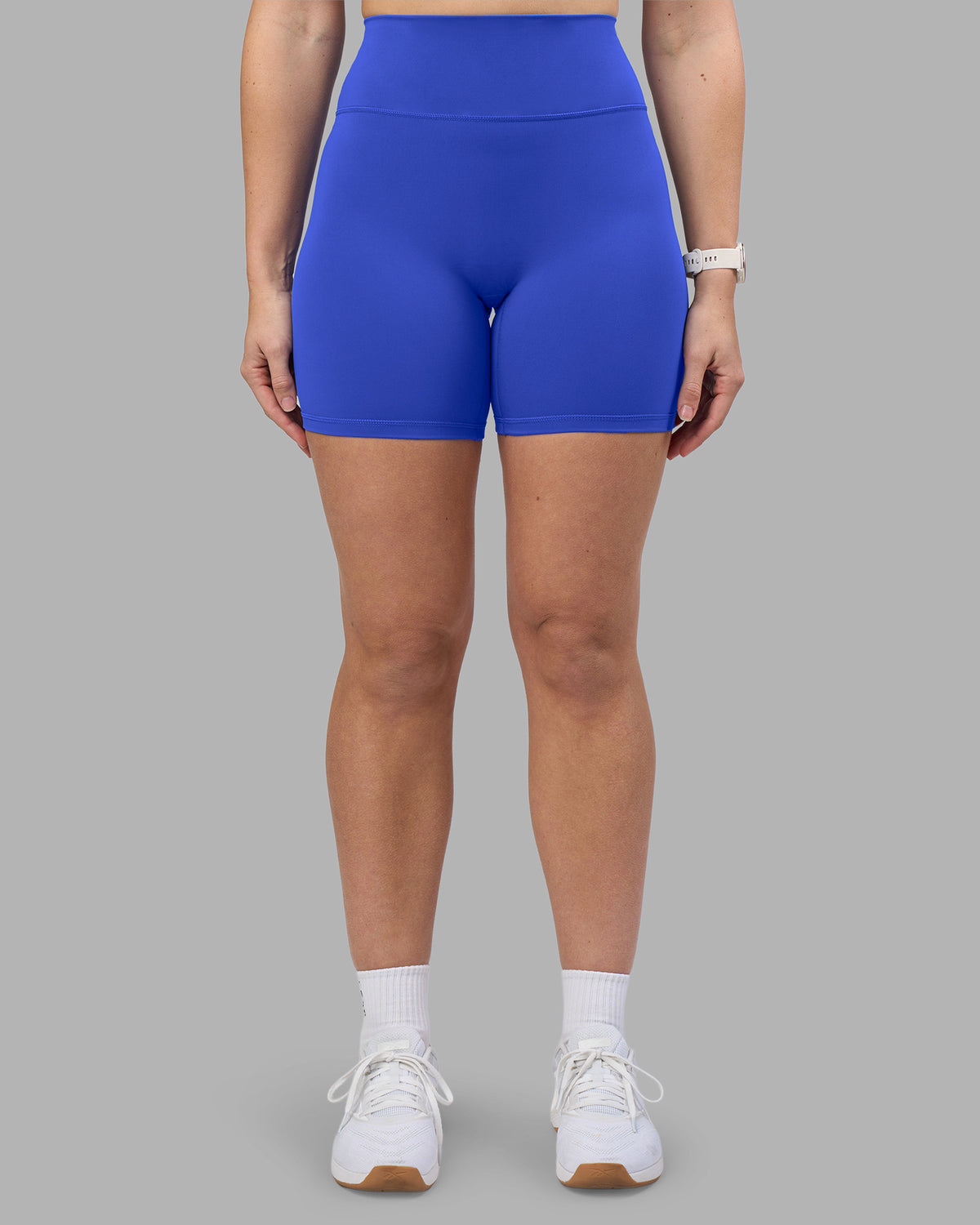 Woman wearing Fusion Ultra High-Rise 6" Short - Power Cobalt | Set:true | Angle:front | Model:Amy | Size:M