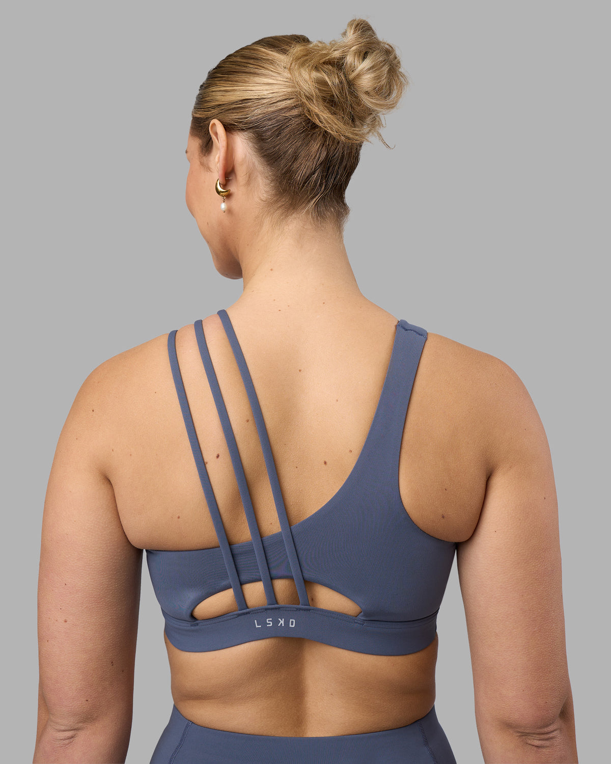 Woman wearing Galvanise Sports Bra 2.0 - Night Shadow | Set:true | Angle:back | Model:Amy | Size:M