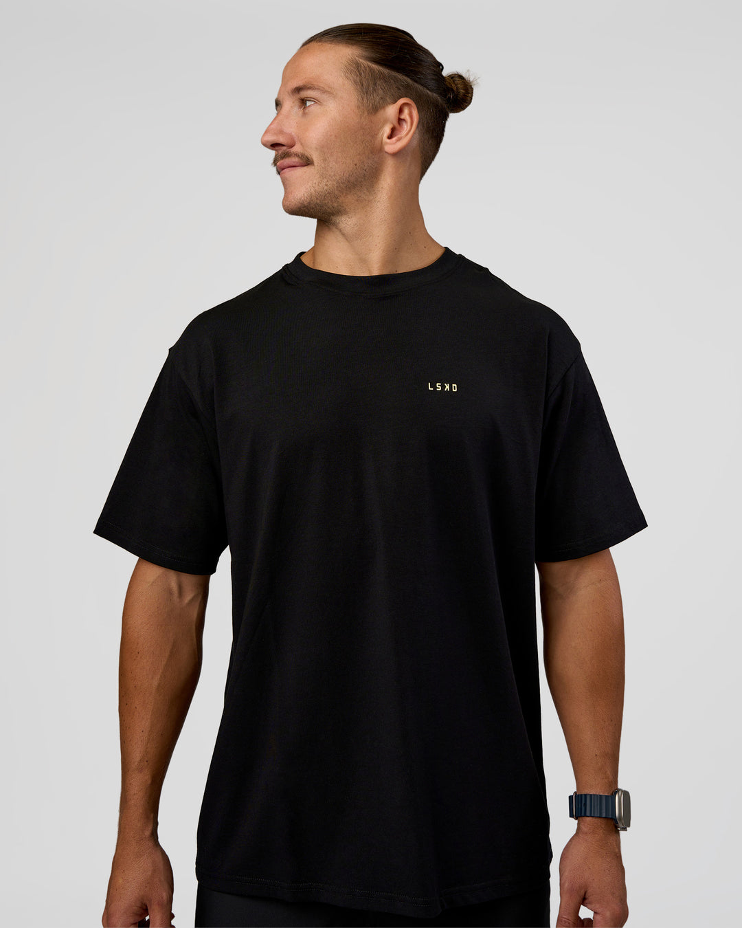 Man wearing High Run FLXCotton Oversized Tee - Black-Yellow Fizz | Model:Jaiden | Size:M - view 2