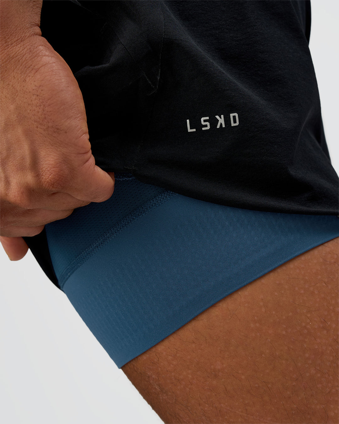 Man wearing Hybrid Lined 5" Short - Black-Indigo | Model:Daarian | Size:M - view 2