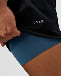 Man wearing Hybrid Lined 5" Short - Black-Indigo | Model:Daarian | Size:M | Thumbnail Index: 1