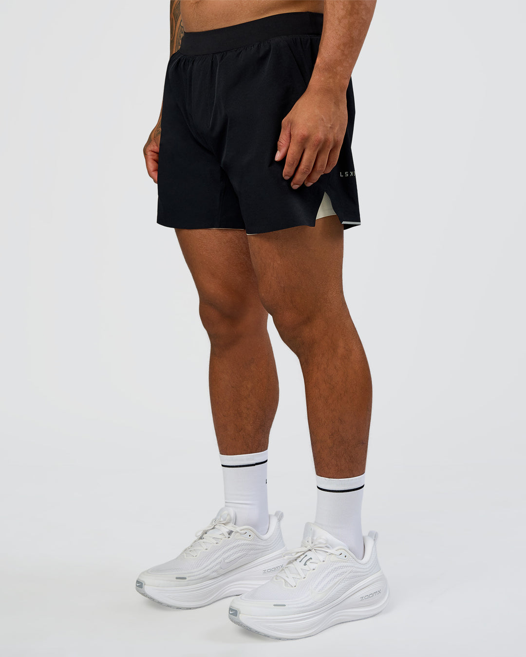 Man wearing Hybrid Lined 5" Short - Black-Shale Beige | Model:Daarian | Size:M - view 6