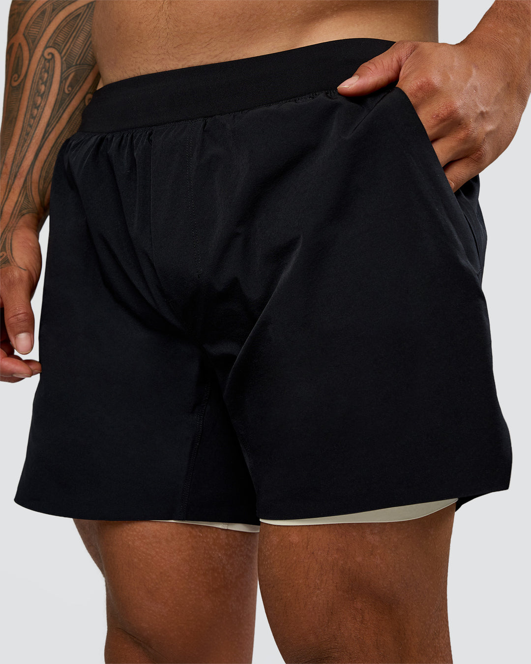 Man wearing Hybrid Lined 5" Short - Black-Shale Beige | Model:Daarian | Size:M - view 1