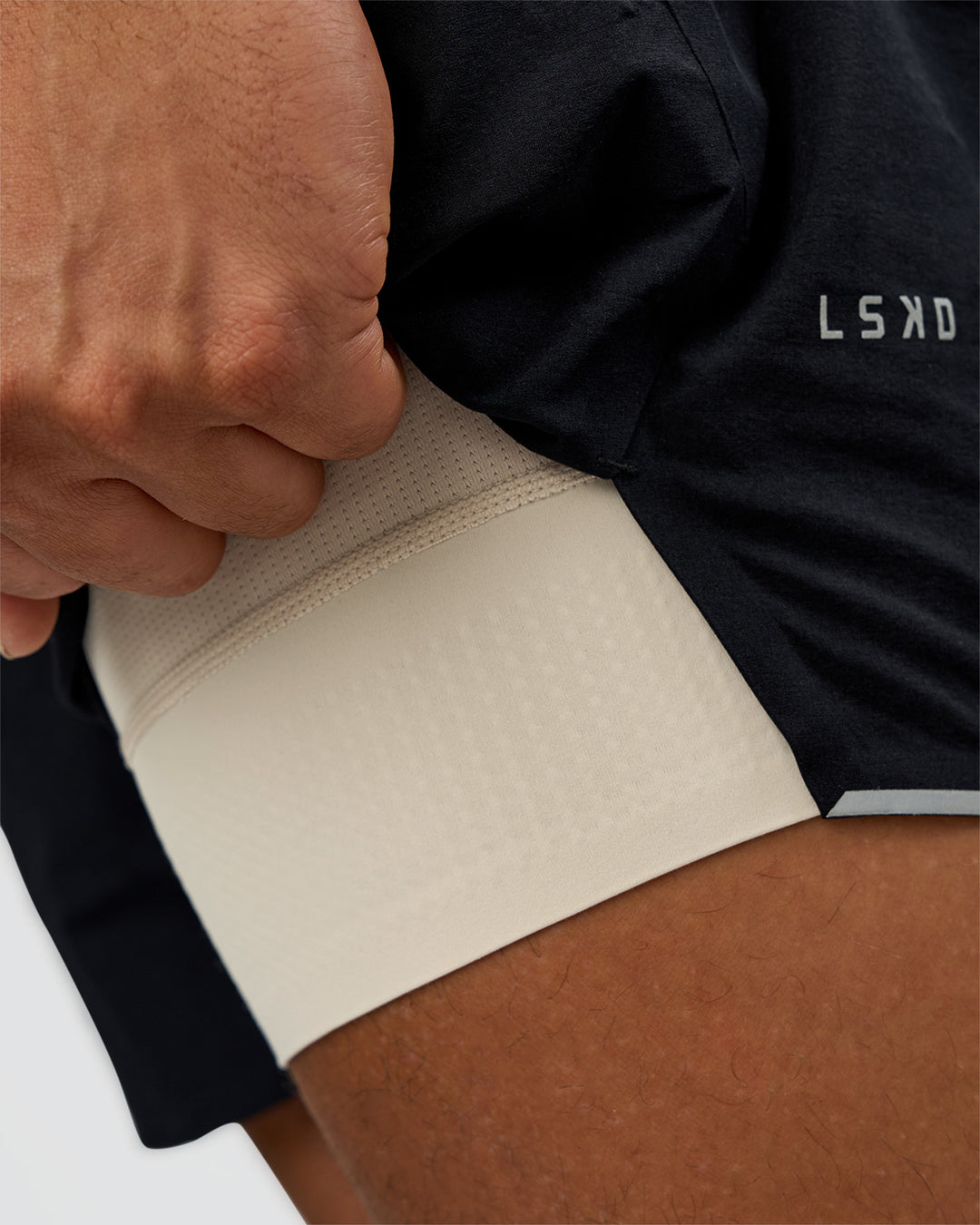 Man wearing Hybrid Lined 5" Short - Black-Shale Beige | Model:Daarian | Size:M - view 8