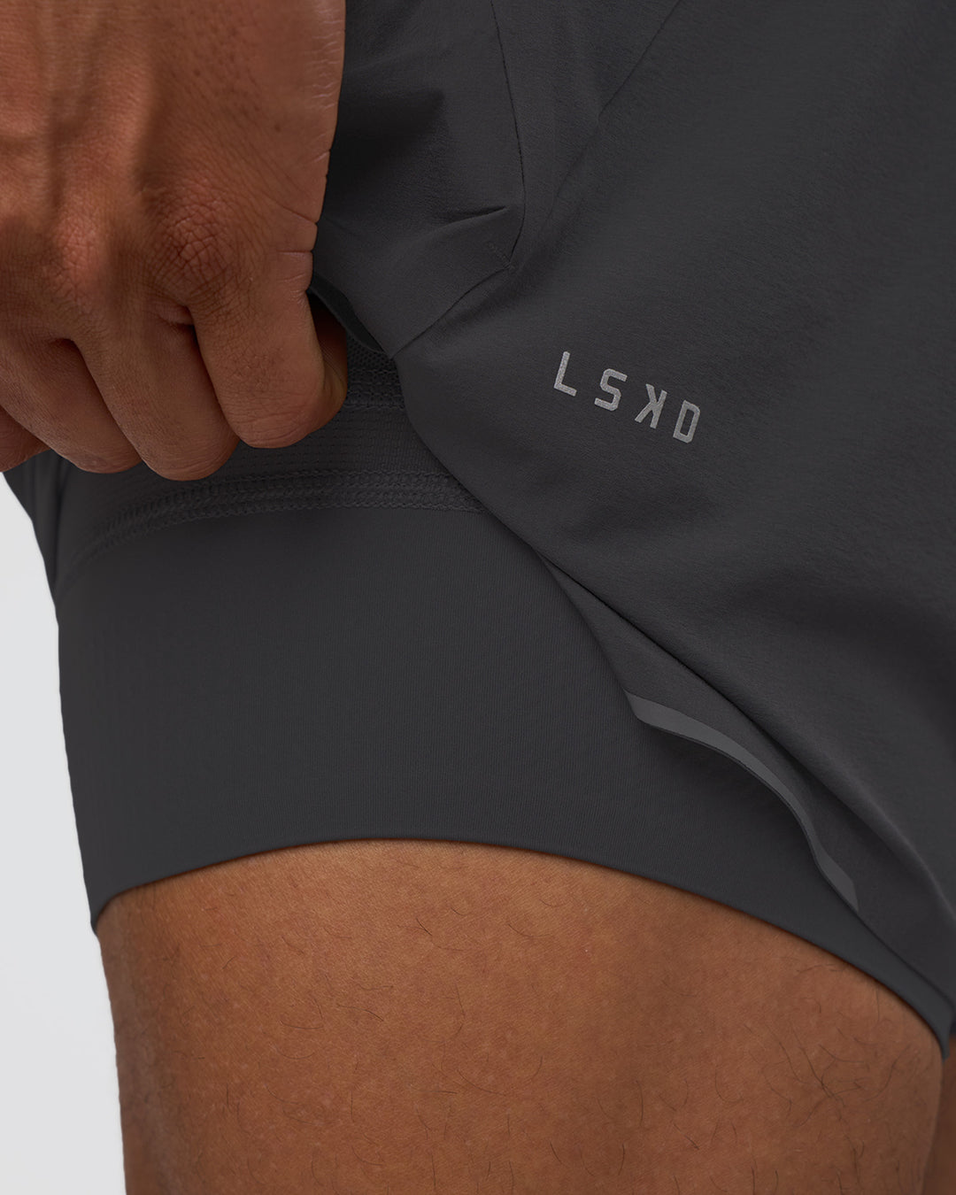 Man wearing Hybrid Lined 5" Short - Dark Storm | Model:Daarian | Size:M - view 2