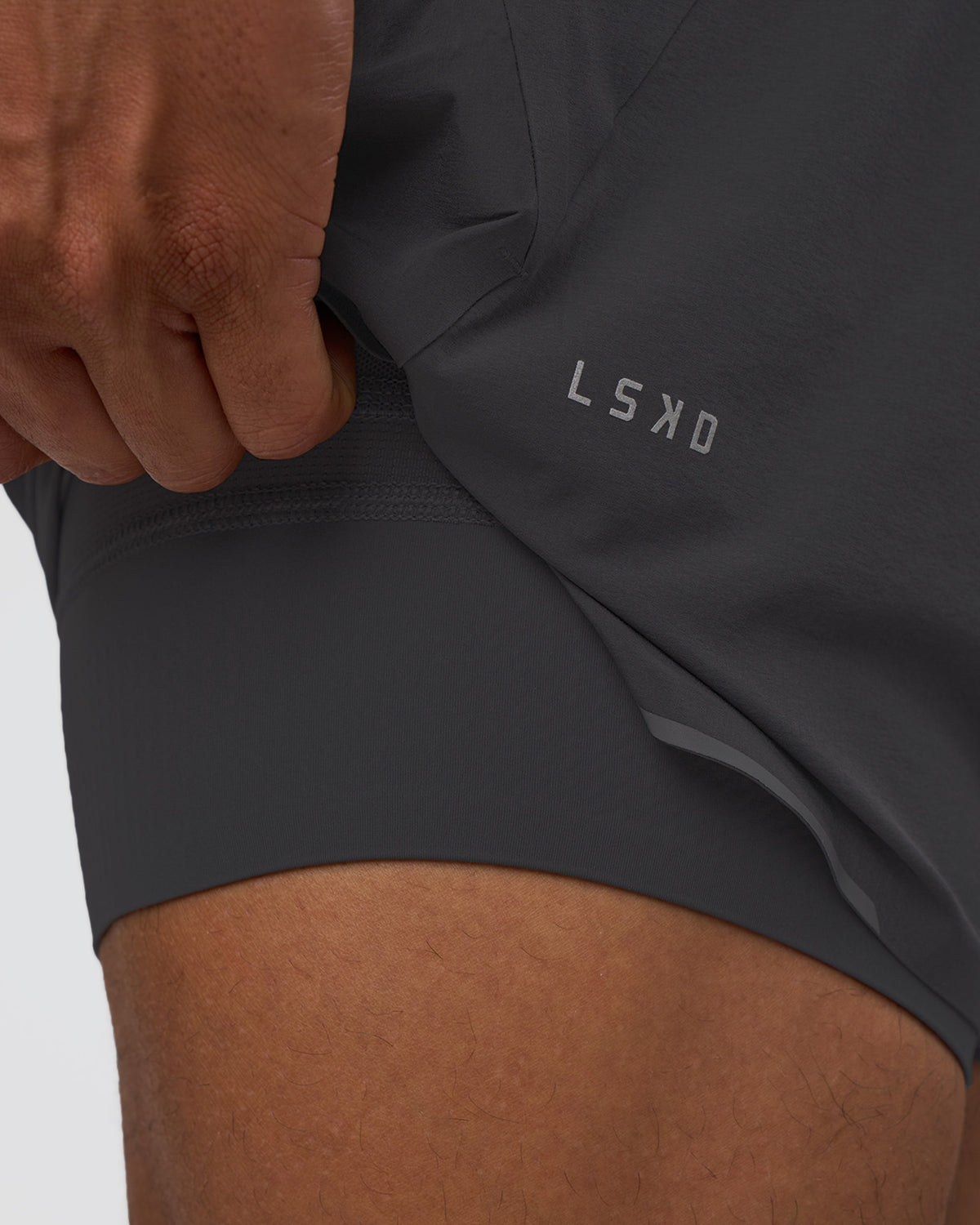 Man wearing Hybrid Lined 5" Short - Dark Storm | Model:Daarian | Size:M