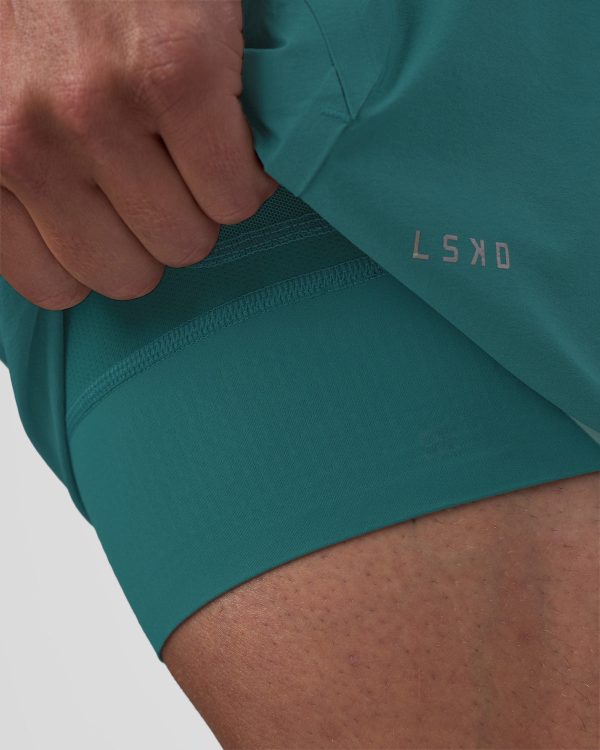 Man wearing Hybrid Lined 5" Short - Transformative Teal | Model:Konnor | Size:M
