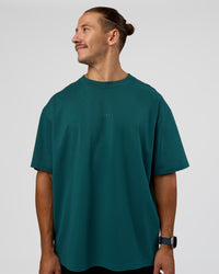 Man wearing MVP 2.0 Oversized Tee - Transformative Teal | Model:Jaiden | Size:M | Thumbnail Index: 1