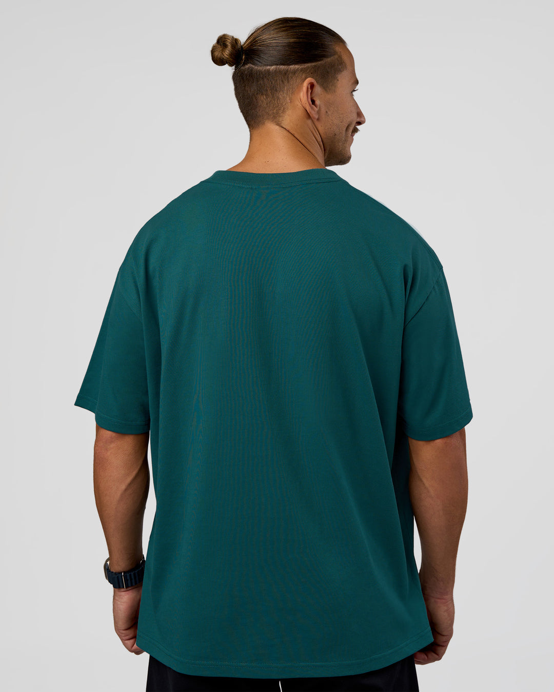Man wearing MVP 2.0 Oversized Tee - Transformative Teal | Model:Jaiden | Size:M - view 6