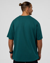 Man wearing MVP 2.0 Oversized Tee - Transformative Teal | Model:Jaiden | Size:M | Thumbnail Index: 5