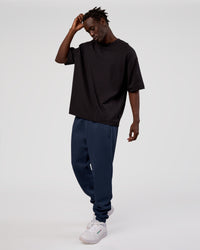 Man wearing MVP Cuffed Track Pant - Future Navy | Model:Okello | Size:M | Thumbnail Index: 1