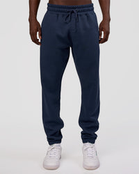 Man wearing MVP Cuffed Track Pant - Future Navy | Model:Okello | Size:M | Thumbnail Index: 0