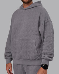 Man wearing MVP Quilted Oversized Hoodie - Storm Front-Geometric | Model:Macca | Size:M | Thumbnail Index: 11