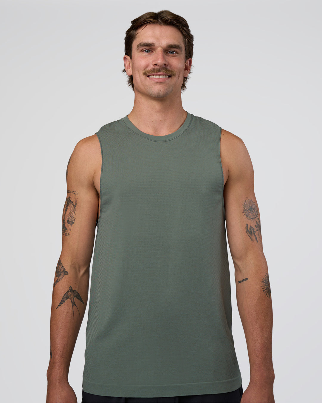 Man wearing AeroFLX+ Seamless Muscle Tank - Graphite/Graphite | Model:Konnor | Size:M - view 1
