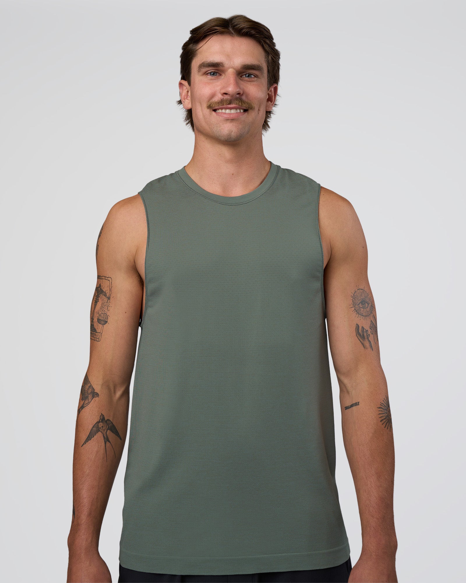 Man wearing AeroFLX+ Seamless Muscle Tank - Graphite/Graphite | Model:Konnor | Size:M