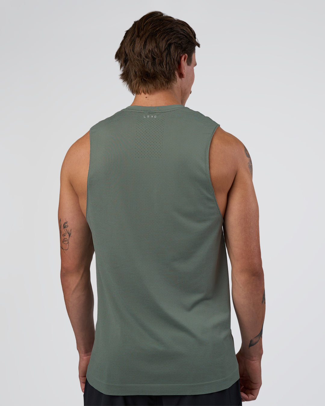 Man wearing AeroFLX+ Seamless Muscle Tank - Graphite/Graphite | Model:Konnor | Size:M - view 3
