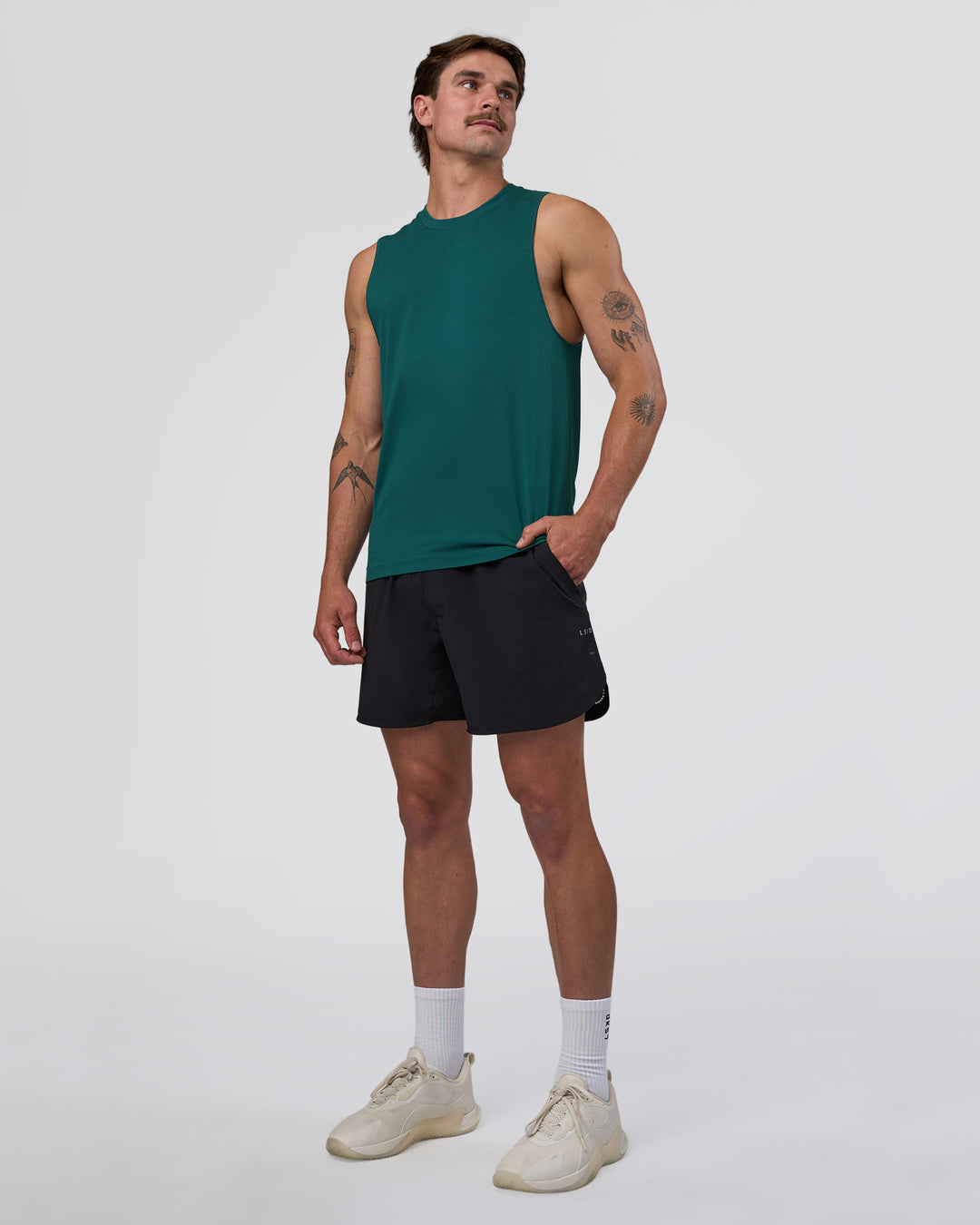 Man wearing AeroFLX+ Seamless Muscle Tank - Transformative Teal/Transformative Teal | Model:Konnor | Size:M - view 4