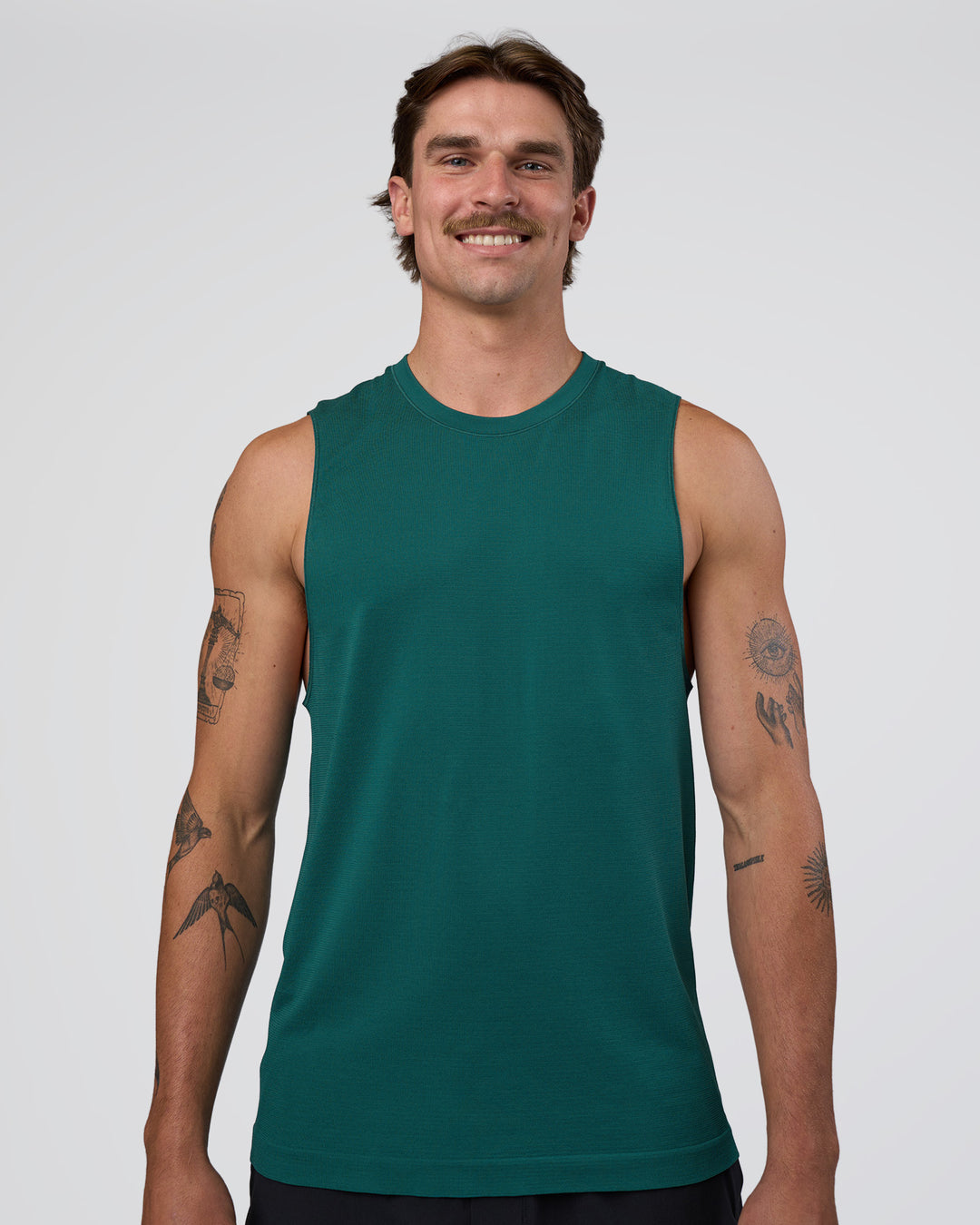 Man wearing AeroFLX+ Seamless Muscle Tank - Transformative Teal/Transformative Teal | Model:Konnor | Size:M - view 1