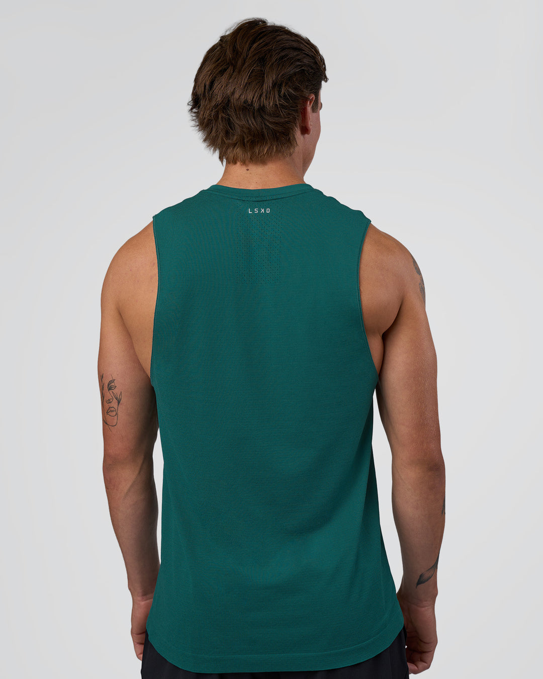 Man wearing AeroFLX+ Seamless Muscle Tank - Transformative Teal/Transformative Teal | Model:Konnor | Size:M - view 3