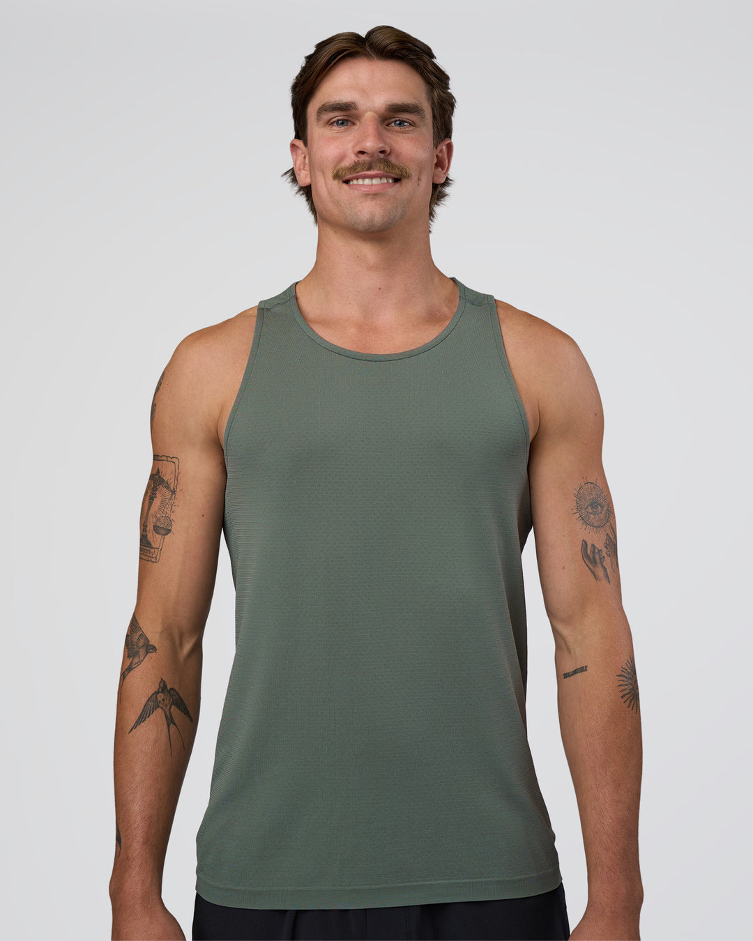 Man wearing AeroFLX+ Seamless Tank - Graphite/Graphite | Model:Konnor | Size:M - view 1