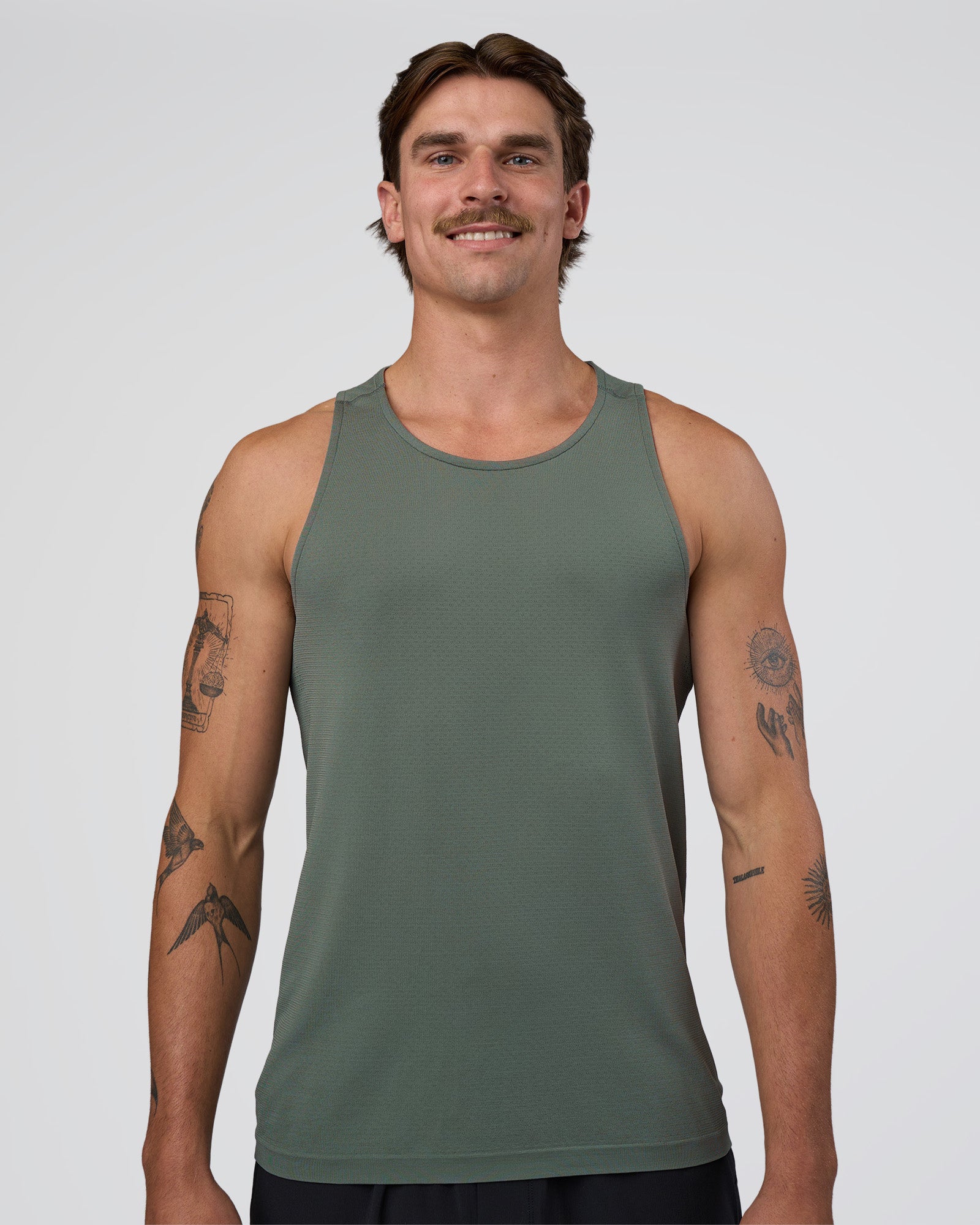 Man wearing AeroFLX+ Seamless Tank - Graphite/Graphite | Model:Konnor | Size:M