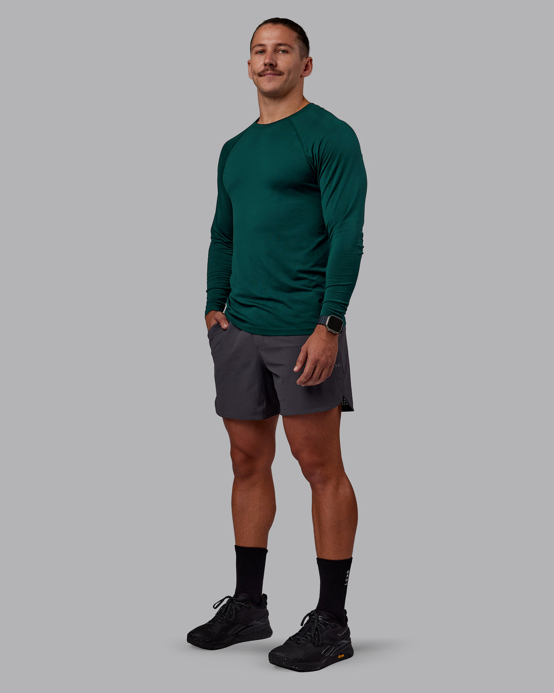 Man wearing AeroFLX+ Seamless Long Sleeve Tee - Dark Moss/Dark Moss | Model:Jaiden | Size:M - view 1