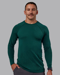 Man wearing AeroFLX+ Seamless Long Sleeve Tee - Dark Moss/Dark Moss | Model:Jaiden | Size:M | Thumbnail Index: 1