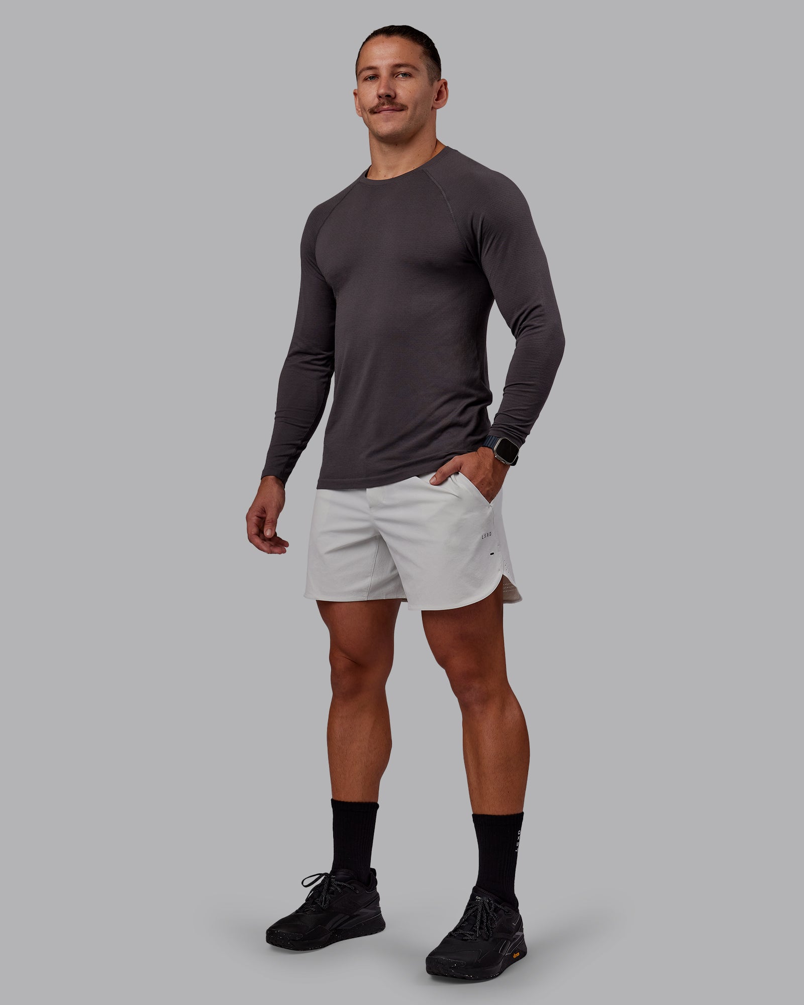 Man wearing AeroFLX+ Seamless Long Sleeve Tee - Dark Storm/Dark Storm | Model:Jaiden | Size:M