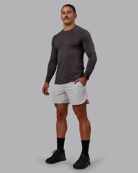 Man wearing AeroFLX+ Seamless Long Sleeve Tee - Dark Storm/Dark Storm | Model:Jaiden | Size:M | Thumbnail Index: 1