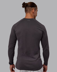 Man wearing AeroFLX+ Seamless Long Sleeve Tee - Dark Storm/Dark Storm | Model:Jaiden | Size:M | Thumbnail Index: 2