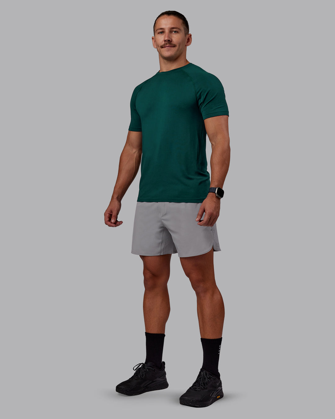 Man wearing AeroFLX+ Seamless Tee - Dark Moss/Dark Moss | Model:Jaiden | Size:M - view 6